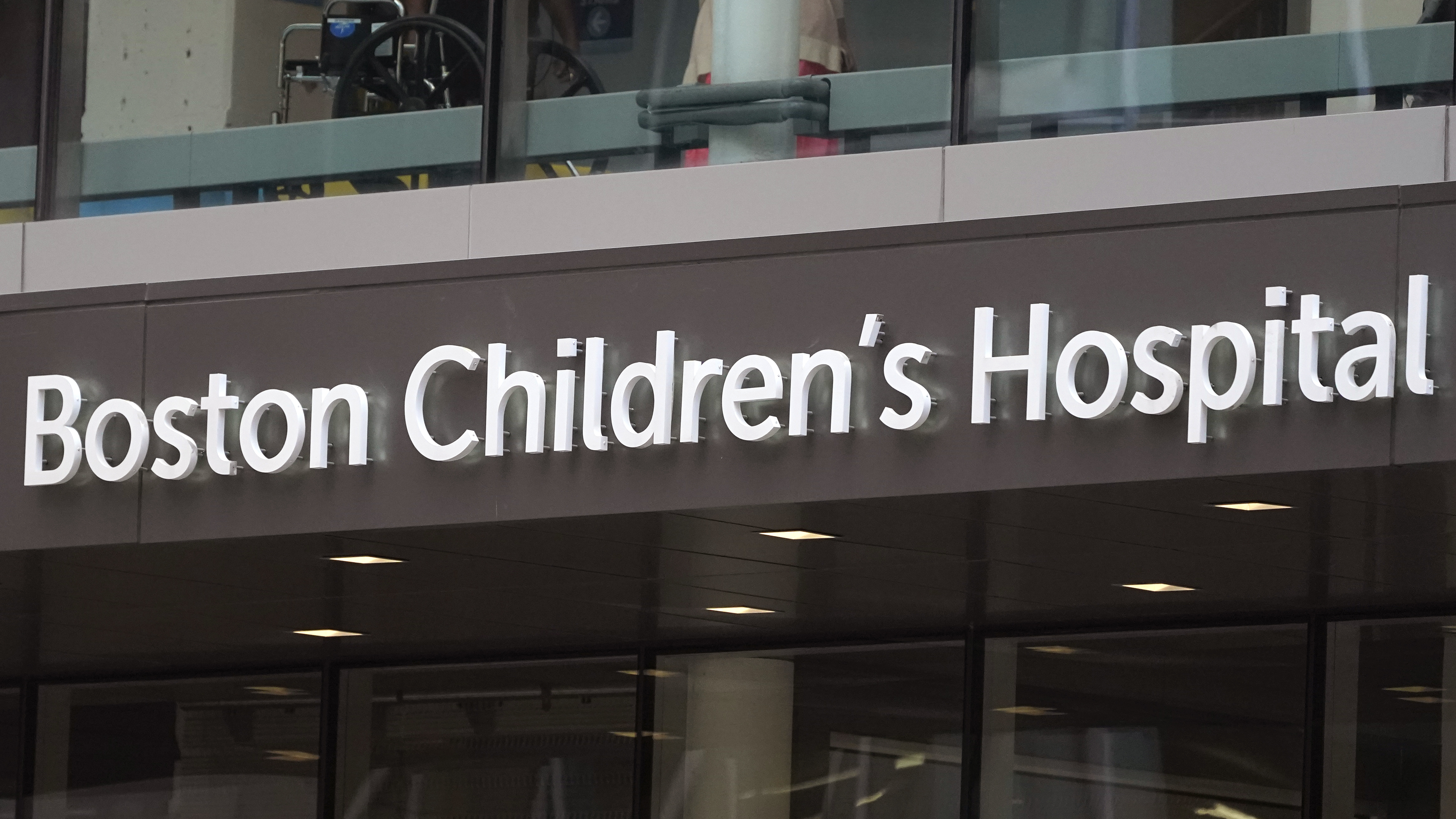 A sign hangs on the Boston Children's Hospital, Thursday, Aug. 18, 2022, in Boston. A Massachusetts woman pleaded guilty on Thursday, Sept. 28, 2023, to calling in a fake bomb threat to Boston Children’s Hospital as it faced a barrage of harassment over its surgical program for transgender youths. (AP Photo/Charles Krupa)