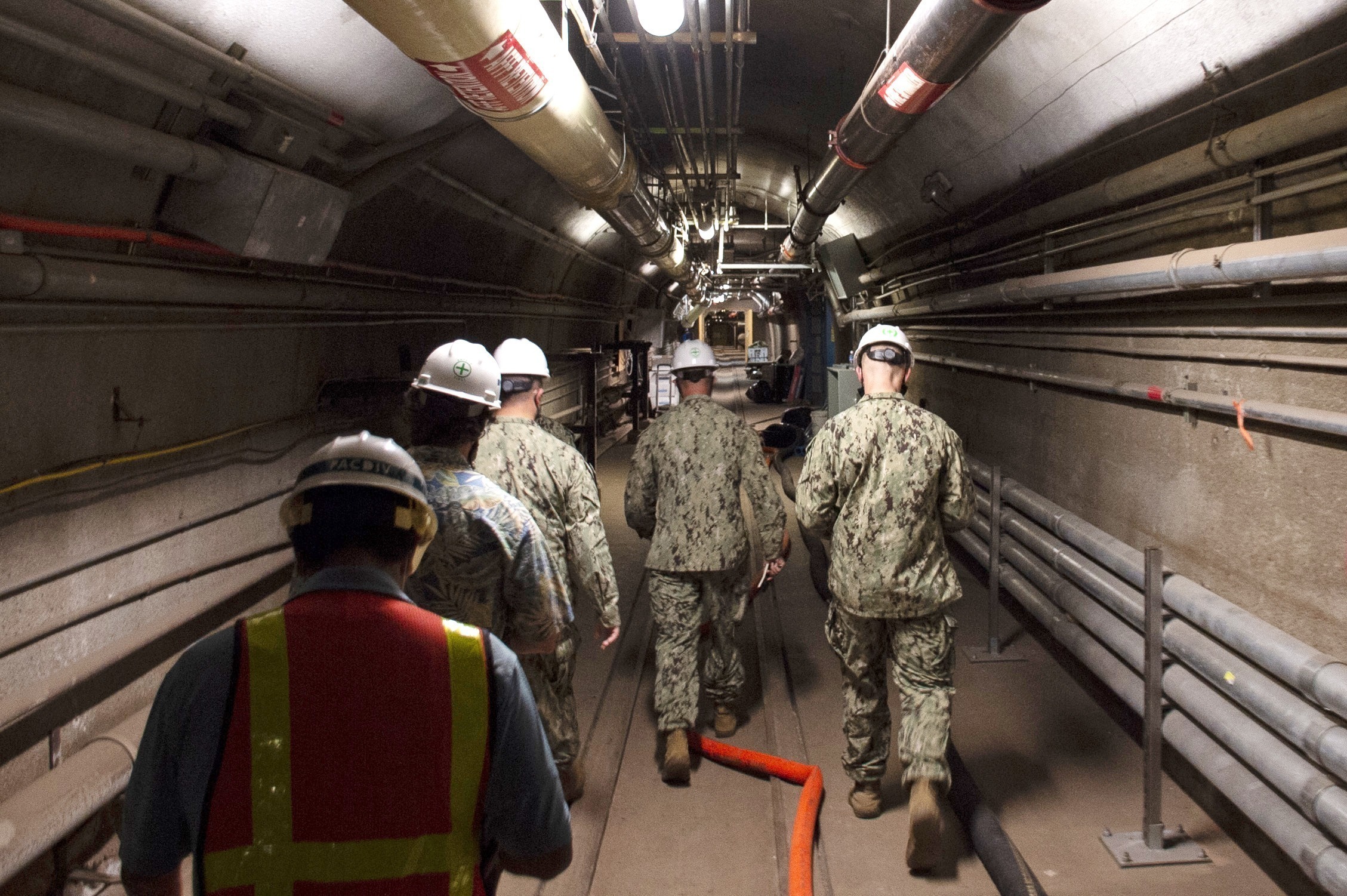 FILE - In this photo provided by the U.S. Navy, Rear Adm. John Korka, Commander, Naval Facilities Engineering Systems Command (NAVFAC), and Chief of Civil Engineers, leads Navy and civilian water quality recovery experts through the tunnels of the Red Hill Bulk Fuel Storage Facility, near Pearl Harbor, Hawaii, Dec. 23, 2021. On Thursday, Sept. 28, 2023, the Navy issued written reprimands to three now-retired military officers for their roles in the spill of jet fuel into Pearl Harbor's drinking water in 2021, but did not fire, suspend, dock the pay or reduce the rank of anyone for the incident. (Petty Officer 1st Class Luke McCall/U.S. Navy via AP, File)