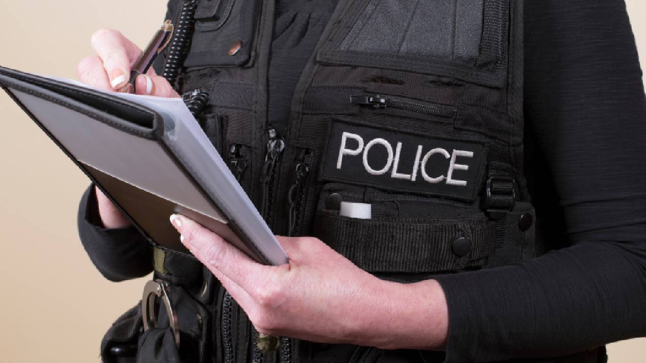 Police officer writing in notebook, police generic